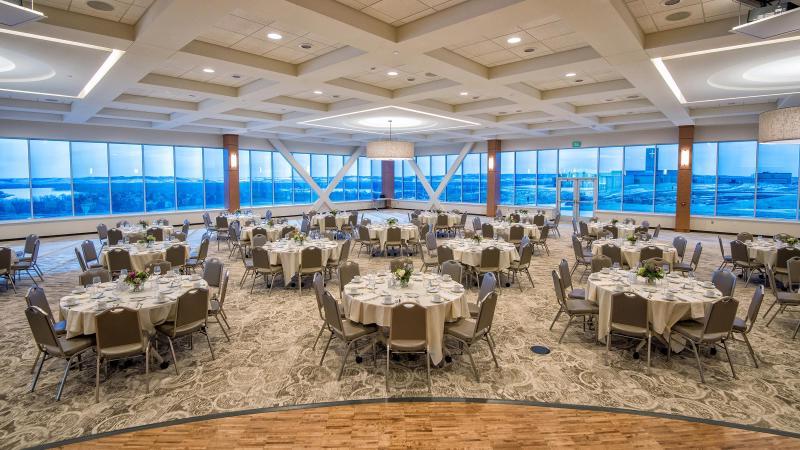 A view from the stage of Founders Hall looking to the back of wall-to-wall windows overlooking the Missouri River Valley.