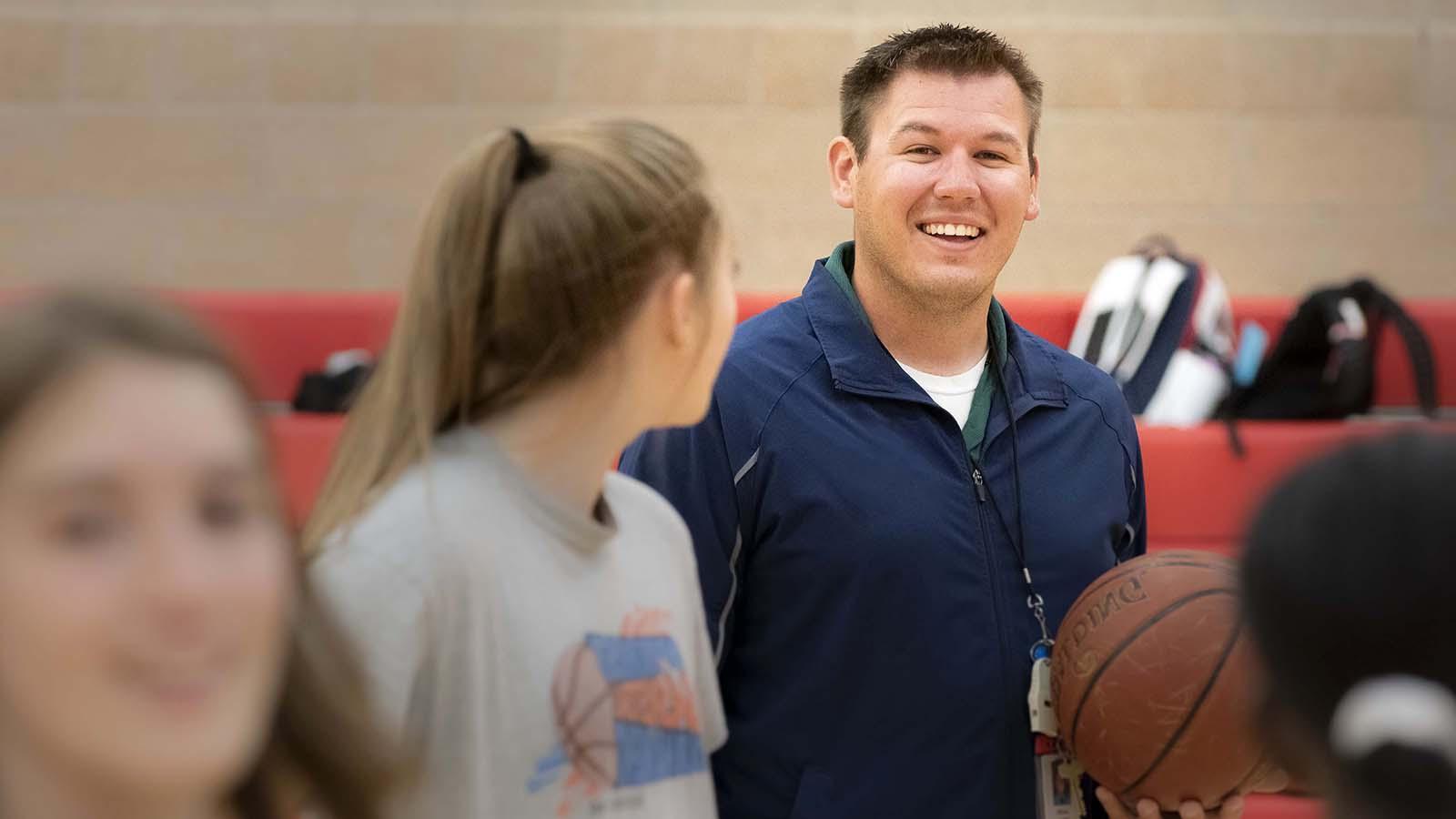 Man coaching high school basketball practice